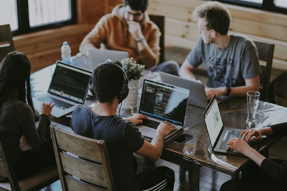 A startup team working together on laptops