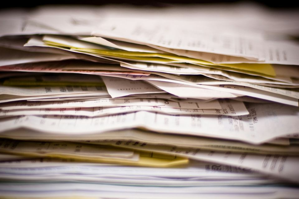 A thick stack of unsorted papers and receipts