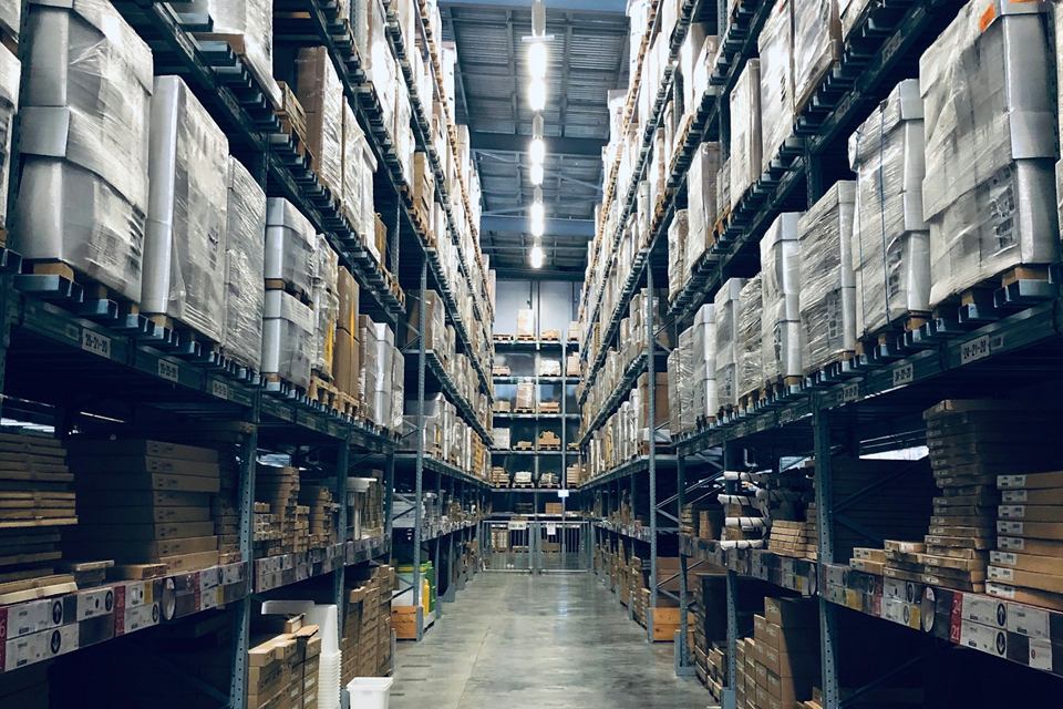 Warehouse aisle lined with stocked shelves